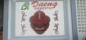 a framed picture of a drawing of a hamsaq at Daeng Homestay in Pangururan