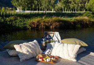 a table with pillows and a tray of food at Oakvale Estate in Franschhoek