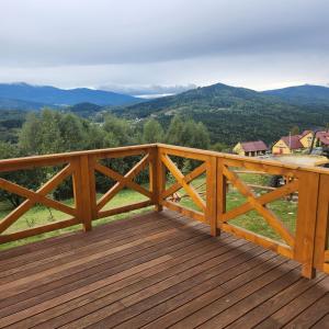a wooden deck with a view of the mountains at Dom z Bali Zawoja z widokiem na Babią Górę in Stryszawa