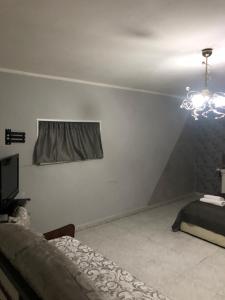 a room with a bed and a chandelier on the wall at Casa di Codo in Naples