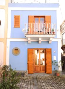 a blue building with a balcony and a door at Casa di Jacopo in Lipari