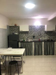 a kitchen with a table and a counter top at Casa di Codo in Naples +13 photos