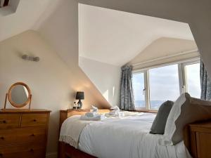 a bedroom with a bed with a large window at Valley View Cottage by MaisonPro in Ebley