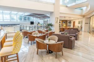 a lobby with tables and chairs and a cafeteria at Sheraton Quito in Quito +146 photos