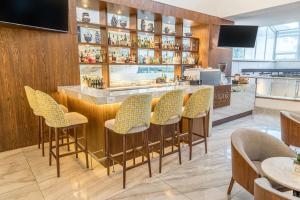 a bar with yellow chairs in a restaurant at Sheraton Quito in Quito