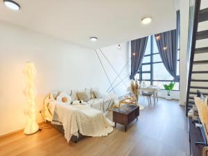 a white living room with a couch and a table at Urban Loft MRT Convenience KLCC Nearby in EKO CHERAS in Kuala Lumpur