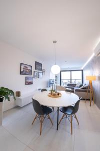 a living room with a white table and chairs at Apartmán NAUTIS in Piešťany +22 photos