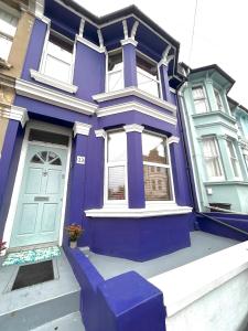 a purple house with a blue door on a street at Hanover House in Brighton & Hove
