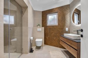 a bathroom with a toilet and a sink at Luxury Tommy's Apartment in Duće +34 photos