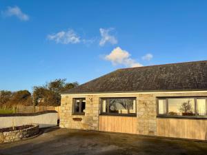 a stone house with a garage at Little Hillside in Redruth