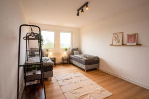 a living room with a bed and a ladder in it at Grammendorf Monteur-Apartments in Grammendorf