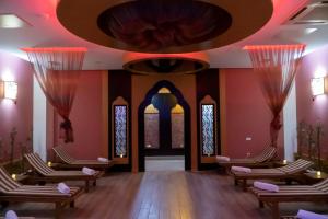 a waiting room with chairs and a large ceiling at Adalya Resort & Spa Adults Only - Ultra All Inclusive in Side