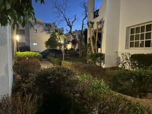 a house with a driveway next to a building at Chalet in Delta Sharm in Sharm El Sheikh