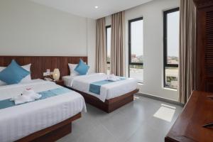 Postel nebo postele na pokoji v ubytování Angkor Channary Hotel
