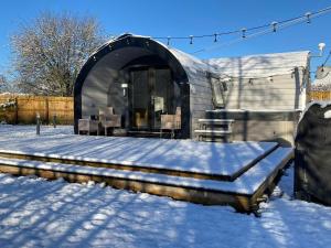 a dome shaped home in the snow with snow on the ground at The Pod at Gerycoed in Llangadog