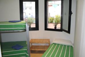 a room with two bunk beds and two windows at Piso SolyMar TRIMAR in Lloret de Mar +52 photos