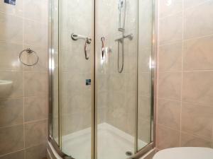 a bathroom with a shower with a toilet at The Oak Lodge in Lyme Regis +22 photos