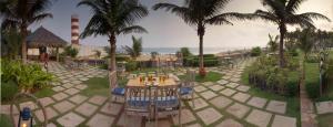 a resort with a table and chairs and a lighthouse at The Park Visakhapatnam in Visakhapatnam
