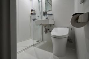 a bathroom with a toilet and a shower and a sink at THE REIGN HOTEL KYOTO in Kyoto +47 photos