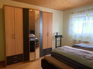a bedroom with two beds and a large closet at Ferienwohnung Ortenau in Neuried
