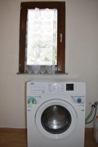 a washing machine in a room with a window at Casa vacanze Pabaule in Gonnesa