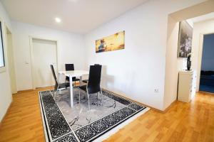 a dining room with a table and chairs at Premium Apartment in Tiddische +8 photos