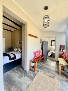 a bedroom with a bed and a couch and a table at Hephzibah Inn Farm Cottage in Hermon +64 photos