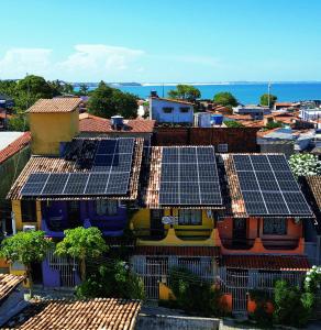 an overhead view of roofs with solar panels on them at Apartamentos Pipa Centro in Pipa