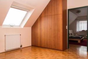an attic room with a skylight and a wooden wall at Privatunterkunft "An der Hecke" in Neuss