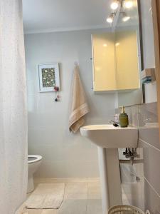 a bathroom with a sink and a toilet and a mirror at Rincón de María - Ganador Traveller Awards 2025 y 2026 in Playa de Gandia +52 photos
