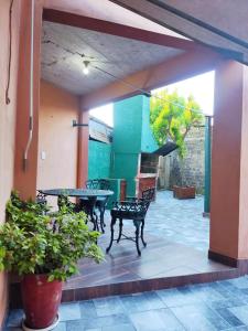 a patio with a table and chairs in a house at Dorita in Villa Elisa