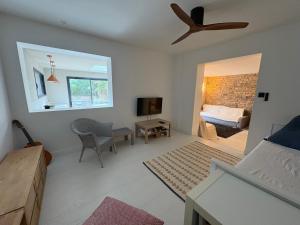 a living room with a bed and a ceiling fan at Villa avec piscine, Sainte Marguerite in Pornichet