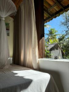 a bedroom with a bed and a window with a view at Casa Del Mar in Marau +37 photos