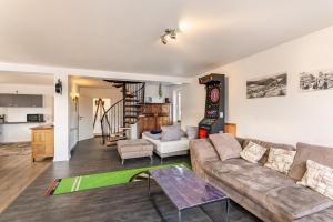 a living room with a couch and a table at Pistenblick in Willingen