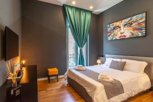 a bedroom with a bed with a painting on the wall at Gram Suites in Naples