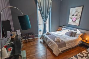a bedroom with a large bed and a large window at Gram Suites in Naples