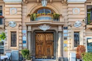 a building with a wooden door and a balcony at Gram Suites in Naples