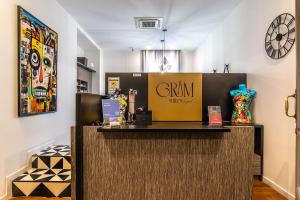 a store counter with a sign on top of it at Gram Suites in Naples