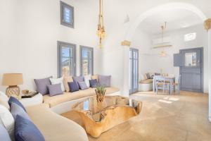 a living room with a couch and a table at Seaside 5BDR Bliss in Mykonos in Merchia Beach