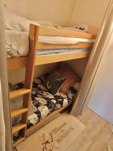 a dorm room with two bunk beds and a sign on the floor at Chaleureux studio pied des pistes Les Glovettes VILLARD DE LANS in Villard-de-Lans +3 photos