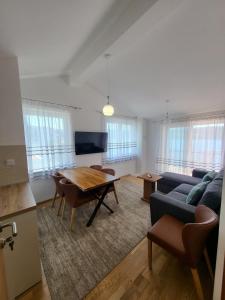 a living room with a table and a couch at Seacoast apartments in Neum