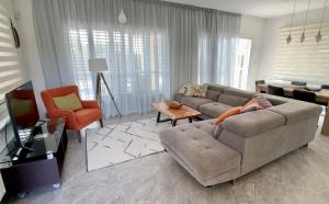 a living room with a couch and a chair at Villa M & S in Coral Bay