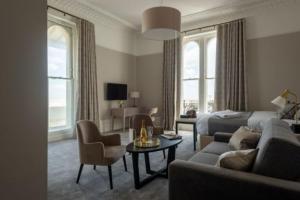 a living room with a couch and a bed at The Burlington in Worthing