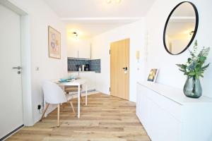 a dining room with a table and a mirror at Zentrumsnahe Ferienwohnung Grüne Tanne WLAN, kostenloser PKW Parkplatz , zwei Betten, Schlafcouch, Küche in Jena