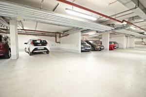 a parking garage with several cars parked in it at Zentrumsnahe Ferienwohnung Grüne Tanne WLAN, kostenloser PKW Parkplatz , zwei Betten, Schlafcouch, Küche in Jena