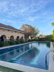 a swimming pool in front of a building at Cute 2 room House with pool access in Tarlac