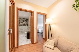 a living room with a couch and a lamp at Serenity Costa da Caparica in Almada +29 photos