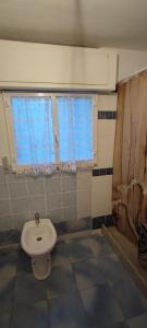 a bathroom with a toilet and a sink at Casa vacanze Pabaule in Gonnesa +16 photos