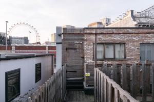 a stairway leading to a building with a ferris wheel in the background at Flat with London Eye view Big Ben Westminister LM4 in London
