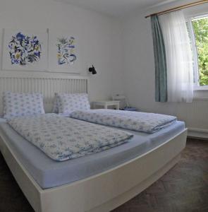 a bedroom with a large bed with blue pillows at Ville Bianche in Drobollach am Faakersee
